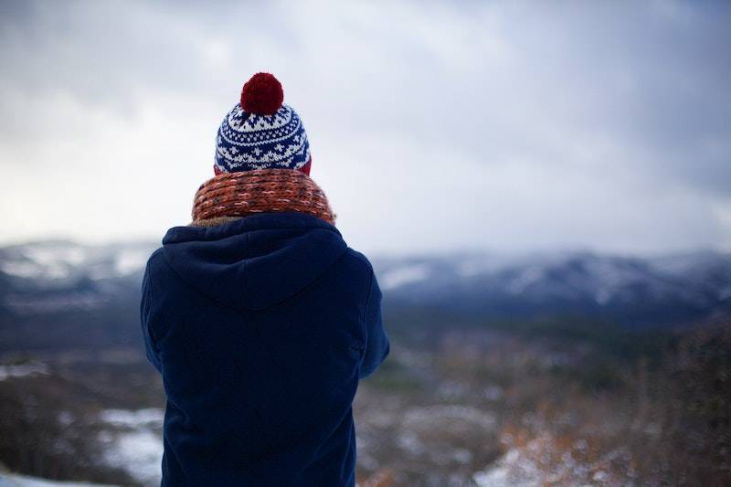 Person stares into wilderness